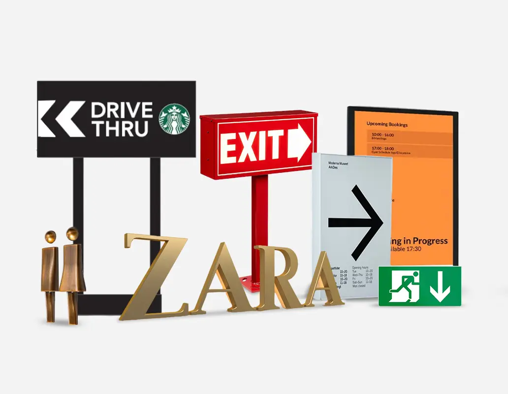 A collection of signage, including directional signs, exit signs, digital displays, restroom symbols, and a Zara logo sign